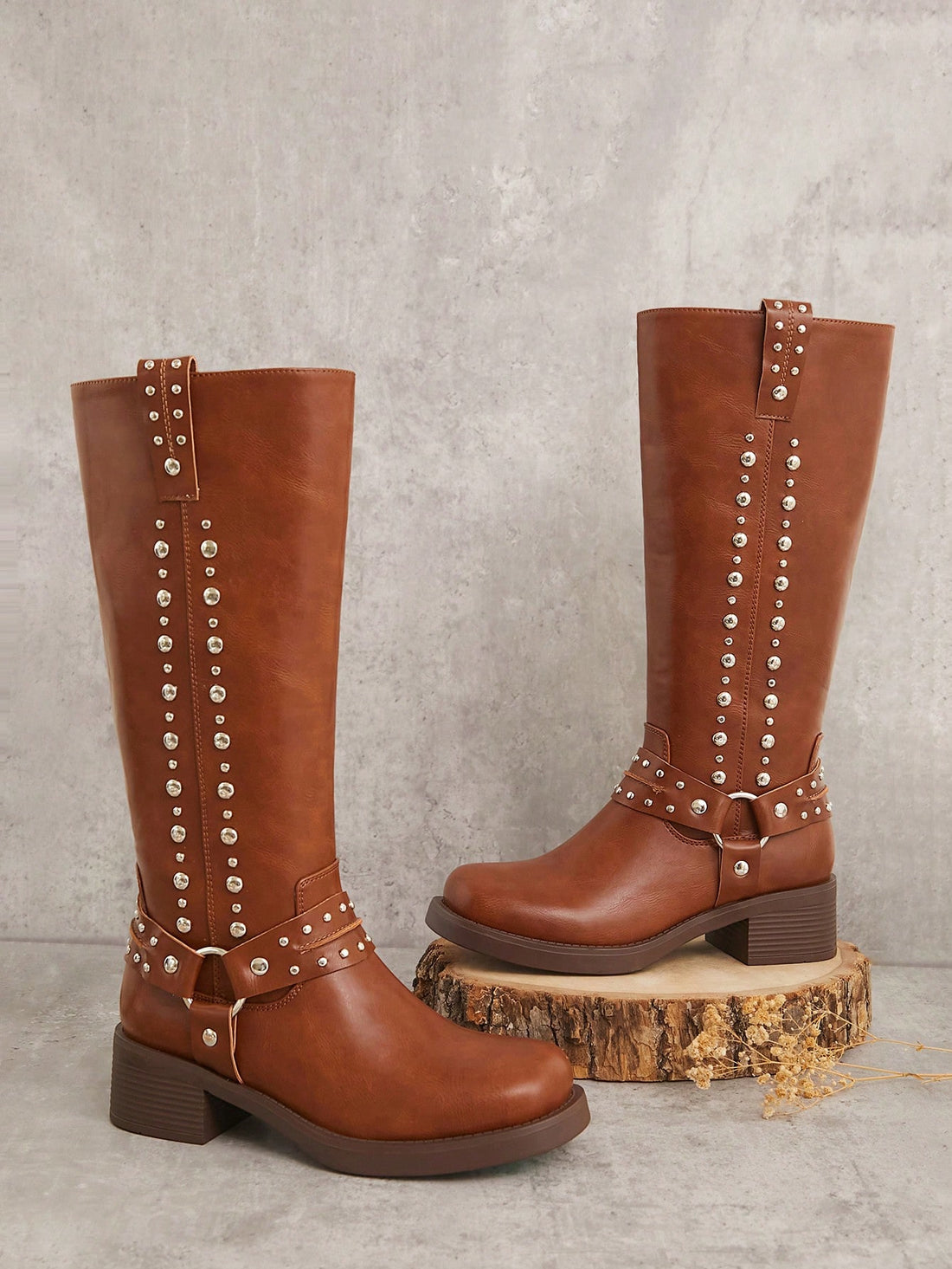 Step out with confidence in these Stylish Two-Lines Studded Tall Boots, designed to turn heads. Featuring bold stud details and a strapped harness, they add an edgy twist to any outfit. Perfect for those who love to make a daring fashion statement while staying comfortable and chic.