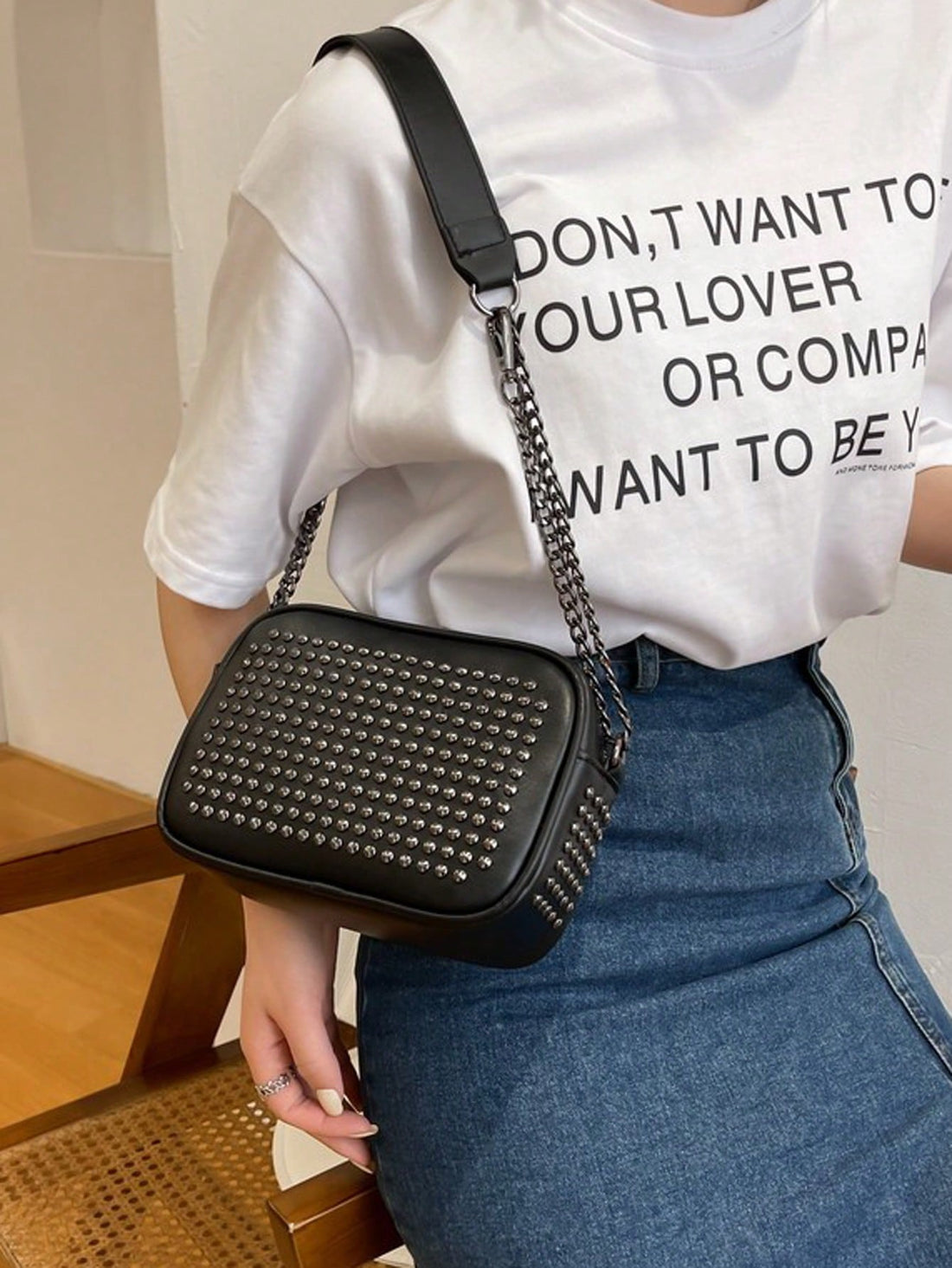 Make a statement with this eye-catching vintage-inspired shoulder bag that effortlessly transitions from day to night. Adorned with edgy rivet detailing, the sleek PU leather construction offers durability without the fuss. Whether you're heading to a wedding, party, or just running errands, this versatile accessory pairs perfectly with any outfit. The comfortable shoulder strap keeps your essentials within reach, while the timeless design ensures you'll reach for it again and again. Vintage charm meets mod