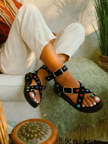Black jeweled platform sandals with multicolor gems on model