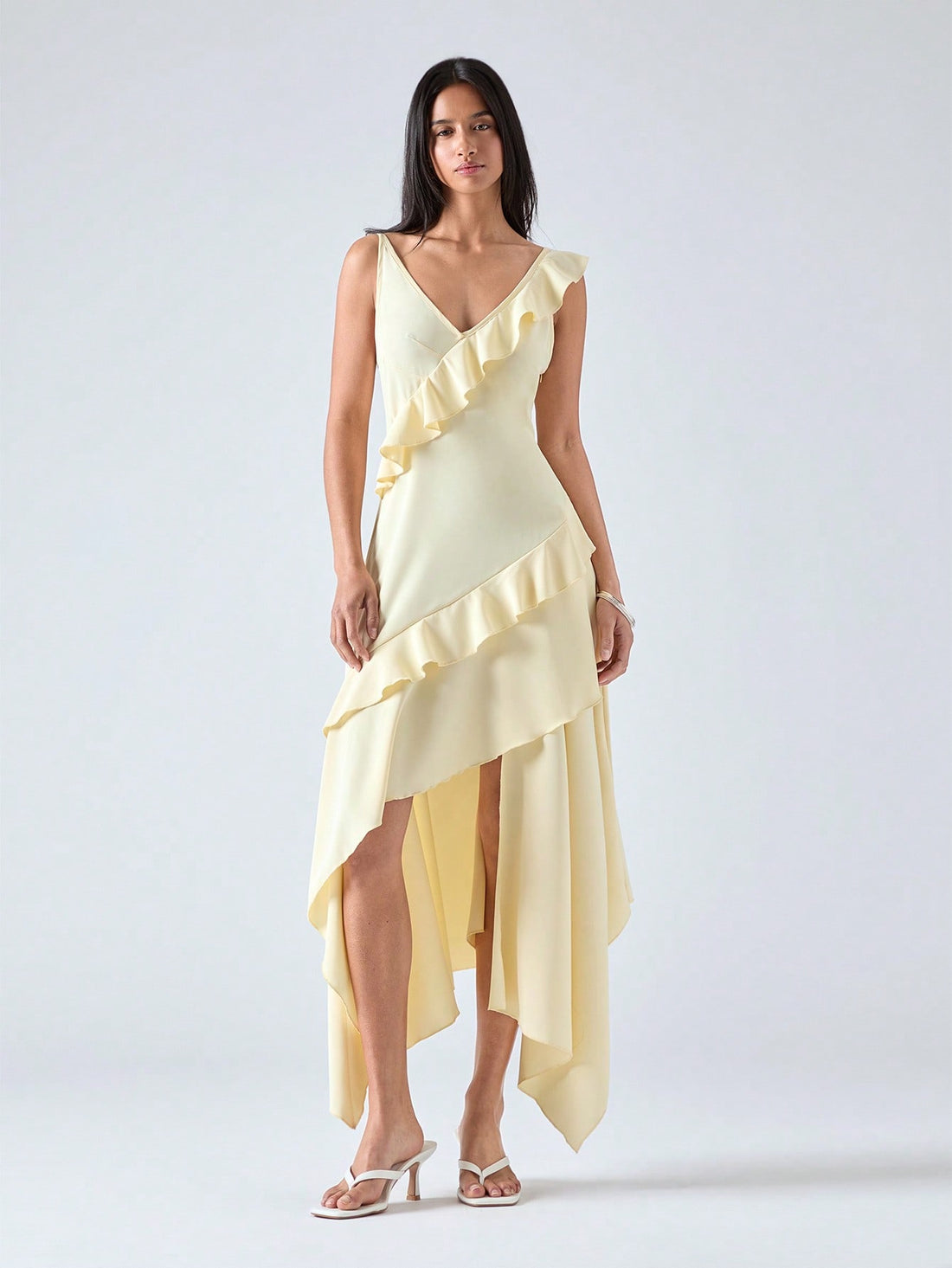 Step into summer with this playful mid-length dress featuring an asymmetric ruffle hem that adds a flirty twist to your look. Lightweight and breezy, it’s perfect for sunny days and warm evenings, combining comfort with effortless style. Whether you're out for brunch or dancing under the stars, this dress brings a fun, elegant vibe to any occasion.