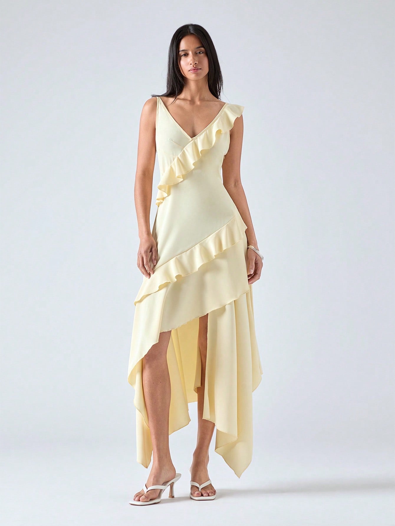 Step into summer with this playful mid-length dress featuring an asymmetric ruffle hem that adds a flirty twist to your look. Lightweight and breezy, it’s perfect for sunny days and warm evenings, combining comfort with effortless style. Whether you're out for brunch or dancing under the stars, this dress brings a fun, elegant vibe to any occasion.