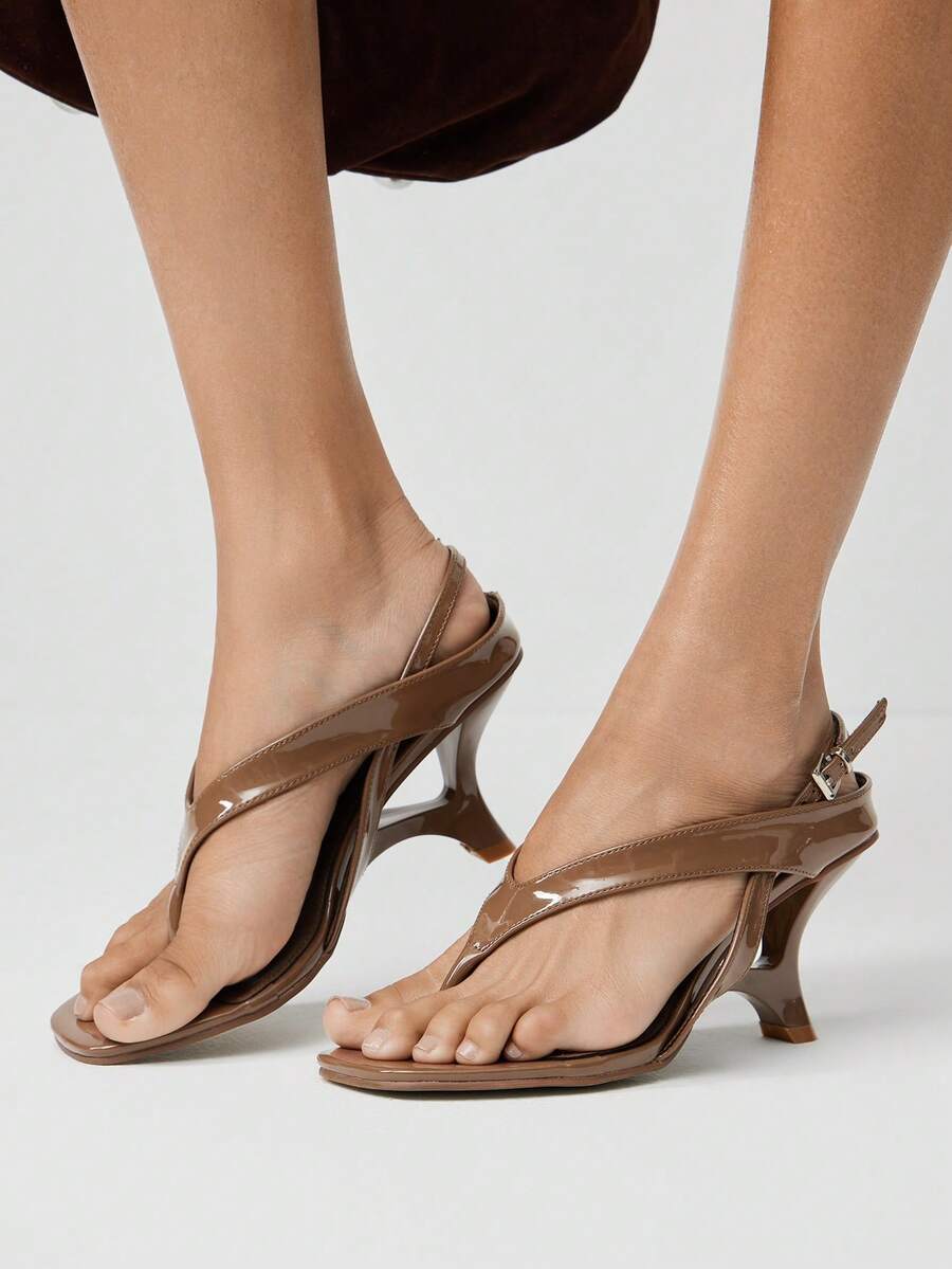 Step into effortless summer style with these sculpted wedge sandals. The thong strap design offers a sleek, minimalist look while the contoured wedge sole provides comfortable all-day support. Perfect for casual outings, beach trips, or weekend adventures. The sculpted footbed hugs your foot naturally, reducing fatigue during extended wear. Versatile enough to pair with shorts, dresses, or casual pants, these sandals are a wardrobe essential for warm-weather dressing.
