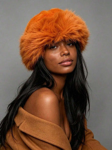 Model in orange plush faux-fur bucket hat with wide curved brim