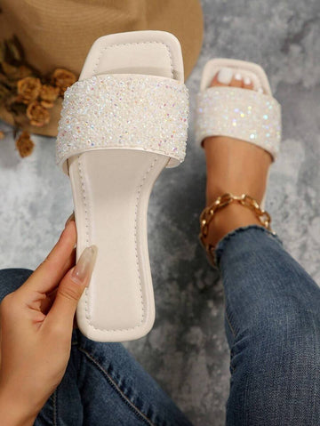 Sparkle into summer with these fabulous rhinestone-studded flat sandals! Designed for women who love a little glitz, these beach slippers combine comfort with eye-catching style. The flat sole keeps your feet happy during long days by the pool or shore, while the shimmering rhinestone details add that perfect touch of glamour. Available in generous sizing to ensure the perfect fit. Whether you're lounging at the beach, running errands, or catching up with friends, these sandals deliver effortless style with
