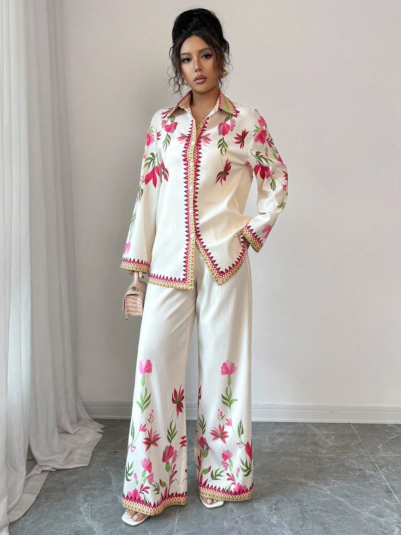 Elevate your fall wardrobe with this vibrant two-piece set that's equal parts fun and fabulous. The long sleeve shirt features eye-catching digital prints in a gorgeous multi-color palette that instantly lifts any outfit, while the coordinating pants offer a comfortable, flattering fit. Perfect for layering on cooler days or standing out at casual gatherings, this set brings effortless style to your everyday rotation. Mix, match, or wear together—either way, you're guaranteed to turn heads this season.