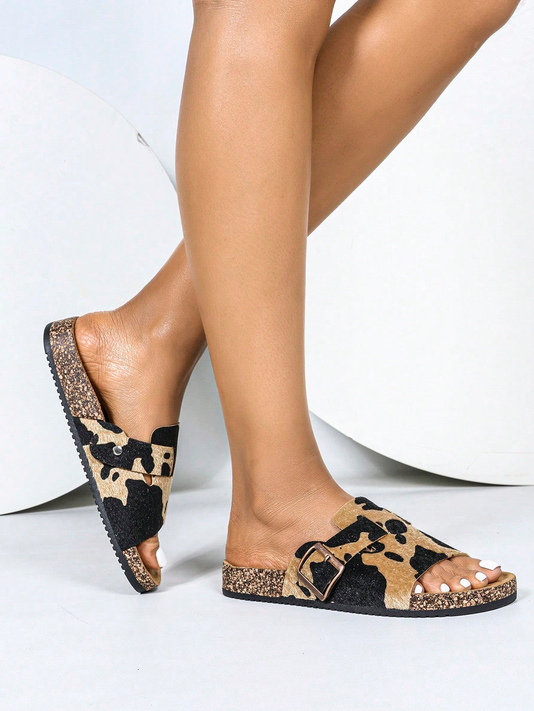 Introducing your new go-to summer sandals: Stylish Women's Open Toe Flat Beach Sandals. With a playful cow print and soft cork sole, these sandals are perfect for all your summer adventures. Stay stylish and comfortable all season long!