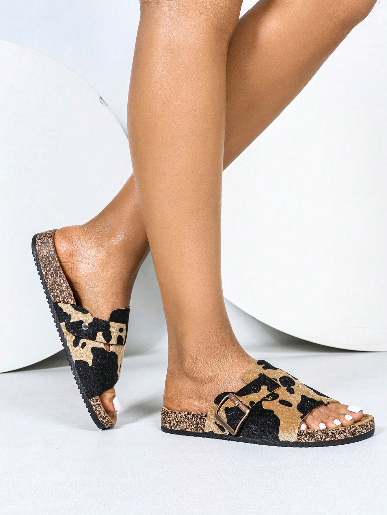 Introducing your new go-to summer sandals: Stylish Women's Open Toe Flat Beach Sandals. With a playful cow print and soft cork sole, these sandals are perfect for all your summer adventures. Stay stylish and comfortable all season long!