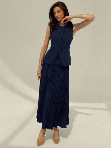 Front view of navy sleeveless waistcoat and pleated maxi skirt suit