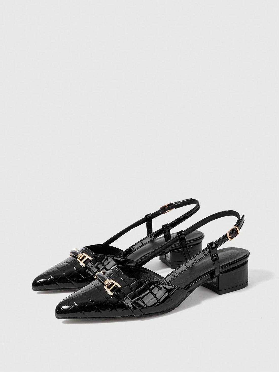 Step into sophistication with these stunning pointed-toe pumps that demand attention. The sleek silhouette elongates your legs while the eye-catching metal buckle accent adds just the right amount of edge and glamour. Perfect for elevating your everyday look or turning heads at special occasions, these high heels deliver confidence with every stride. Whether you're conquering the boardroom or the dance floor, these versatile pumps are your secret weapon for looking absolutely fabulous.