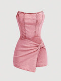 Washed pink strapless denim romper front with corset seams and wrap overlay