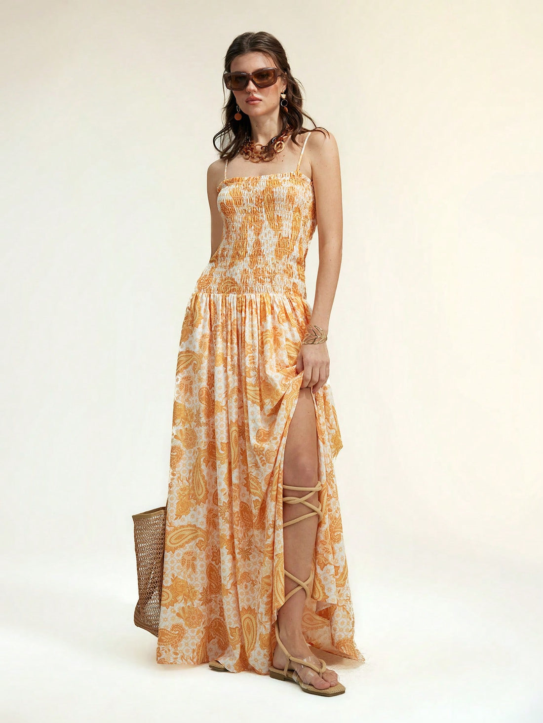 Brighten your summer getaway with this playful yellow paisley maxi dress. Featuring a flirty lace-up front and a breezy side slit, it’s designed to keep you cool and stylish under the sun. Perfect for beach strolls or sunset dinners, this dress combines comfort with a splash of vibrant charm.