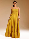 Brighten your summer days with this playful yellow tiered maxi dress. Featuring a strapless smocked bodice, it offers a comfy fit that moves with you. The flowing tiers add a breezy, effortless vibe perfect for sunny outings or beachside strolls. Embrace easy elegance and let your style shine!