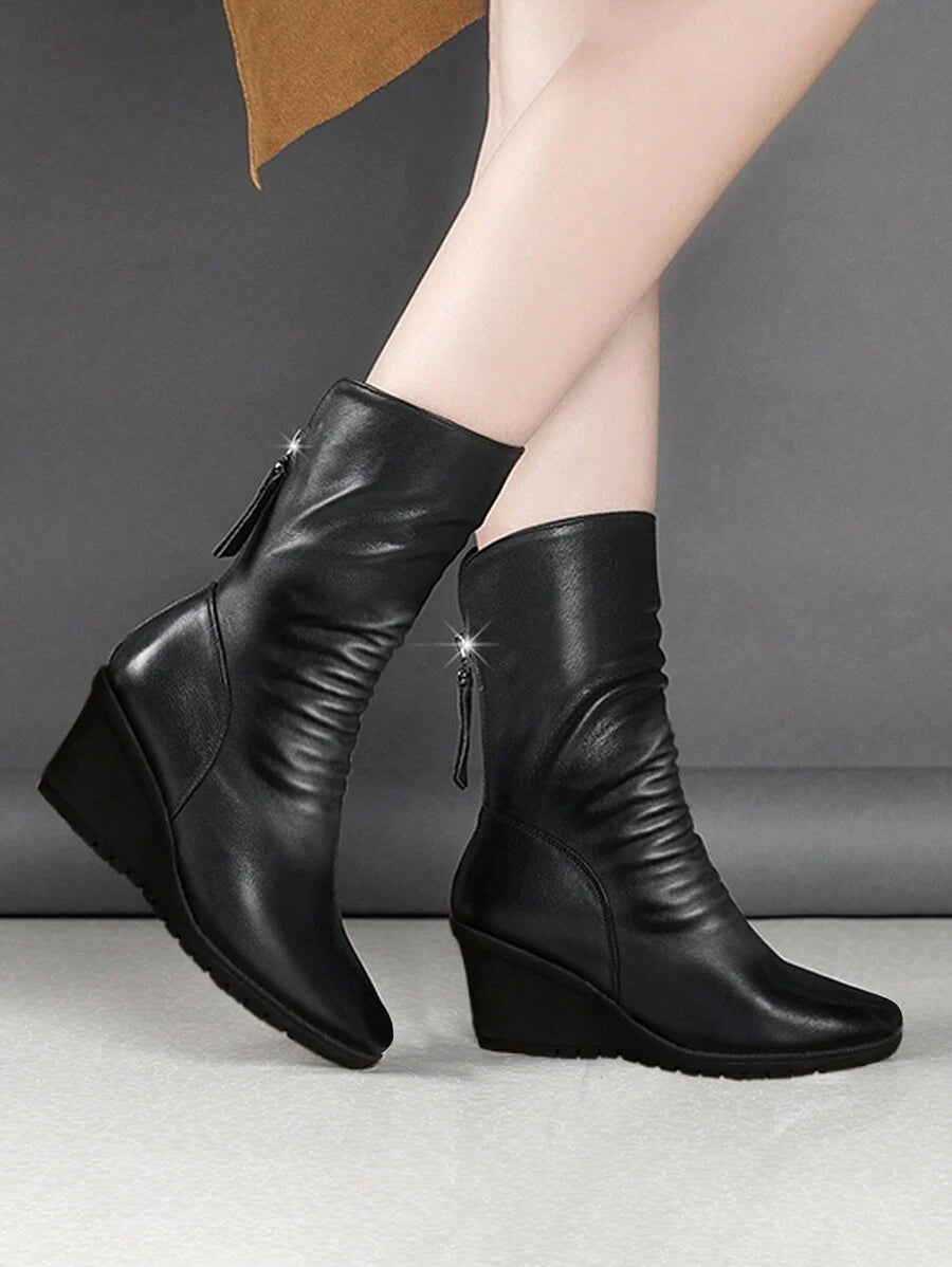 Step into the season with boots that mean business—and style. These mid-calf wedge heel boots blend comfort with that effortless cool factor you've been craving. The flat wedge design keeps you grounded while the sleek silhouette works overtime with everything from jeans to dresses. Perfect for autumn strolls and winter adventures, they're the reliable pair that'll have you reaching for them again and again. Because looking good shouldn't feel like a chore.