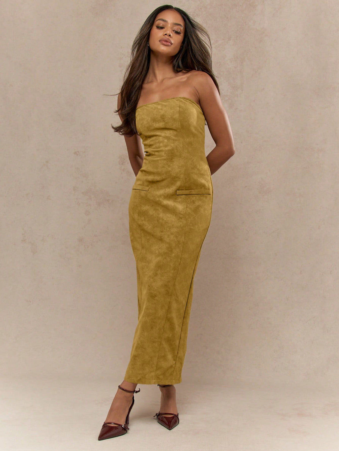Get ready to turn heads in our Suede Bandeau Midaxi Dress! Made with luxe suede fabric, this dress features a sleek zip closure and a flirty back slit hem. Perfect for any occasion, add it to your wardrobe for effortless style. (Zip it up, zip it down, and slay all day in our Suede Bandeau Midaxi Dress!)