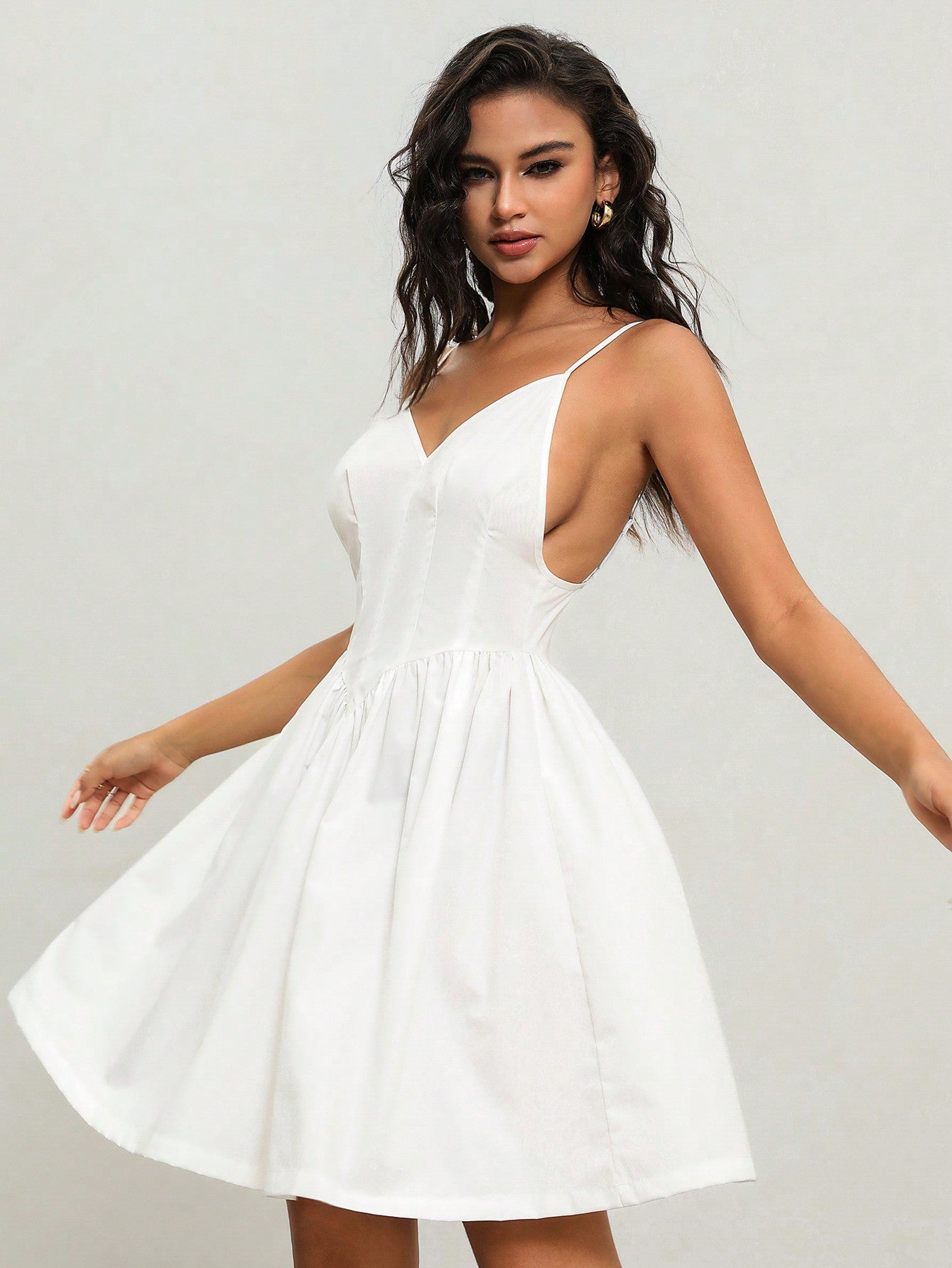 Float through the summer breeze in style with our Casual Backless Cami Dress! This versatile dress features a cinching waist for a flattering fit and a playful backless design. Perfect for any casual occasion, this dress will have you feeling cool, comfortable, and chic all at once.