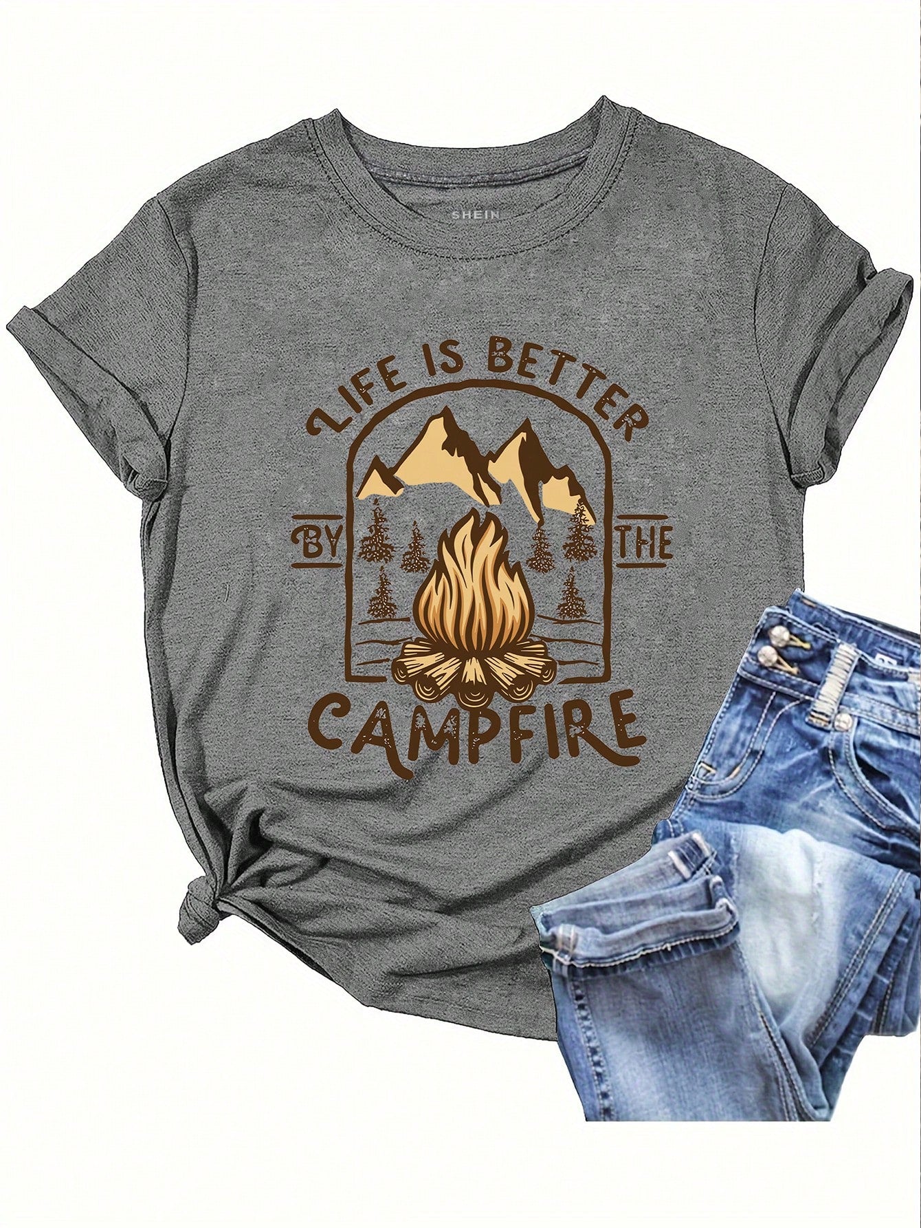 Unleash your inner campfire queen with our 'Life is Better by the Campfire' graphic tee! Perfect for summer nights spent roasting marshmallows and sharing laughs, this tee will show off your love for the great outdoors. Made for comfort and style, it's a must-have for any summer adventure.