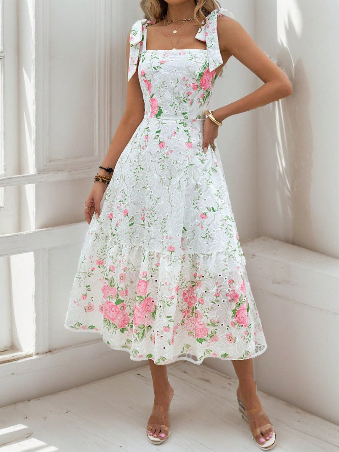 Introducing our Summer Floral Charm dress, featuring a delicate hollow embroidered square neck and a ruffle hem. Made for the warm season, this dress adds a touch of elegance and femininity to any outfit. It's perfect for a summer day out or a special event. Discover the charm of summer with this beautiful dress.