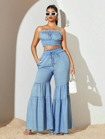 Embrace the season in effortless style with this breezy two-piece set! The delicate ruffle camisole adds a flirty touch while the flowing wide-leg pants deliver comfort and movement. Perfect for casual outings, weekend brunches, or laid-back evenings, this solid-color combo works with everything in your closet. Mix, match, or wear together—either way, you're summer-ready and looking fabulous!