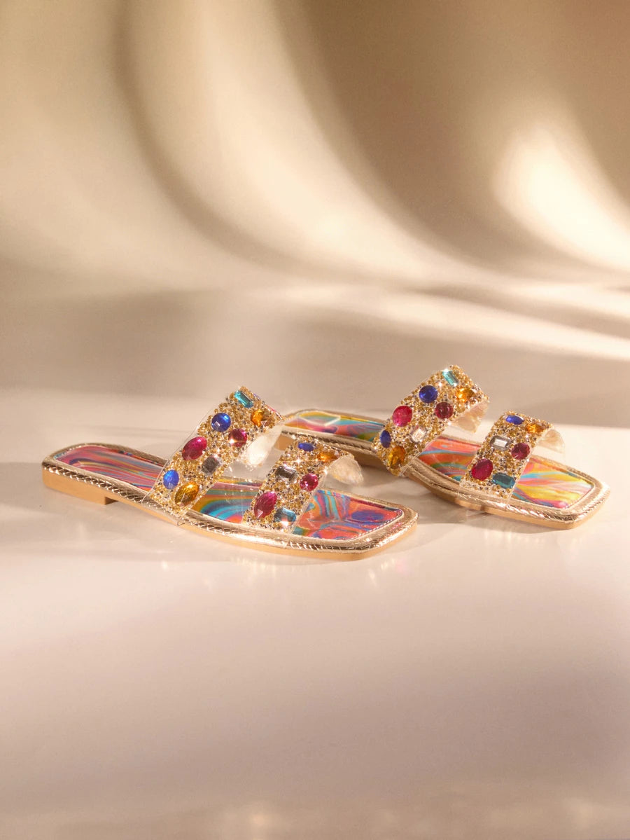 Step into summer with these vibrant rhinestone-embellished flat sandals, designed for effortless style. Featuring colorful crystal accents that catch the light, these versatile sandals transition seamlessly from beach days to casual outings. The comfortable flat sole keeps you supported through all your warm-weather adventures, while the eye-catching embellishments add a touch of sparkle to any outfit. Perfect for poolside lounging, weekend getaways, or everyday wear when you want to shine.