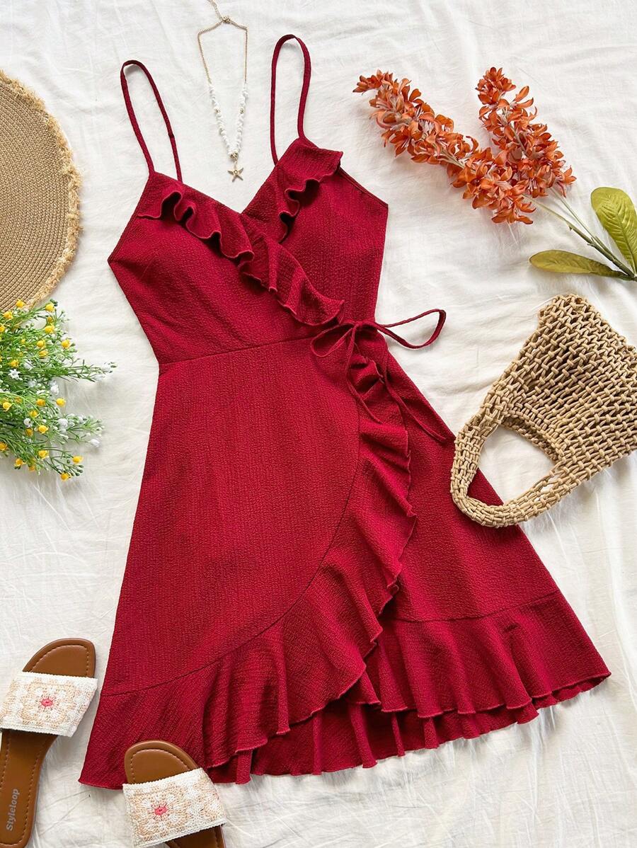 Escape to summer in this charming rose red A-line cami dress. Crafted from textured woven fabric with a hint of stretch, it features delicate spaghetti straps, a flattering high waist, and playful ruffle trim with wrap knot detailing. The mini length and unlined silhouette keep you cool and breezy, while functional pockets add everyday practicality. Perfect for beach days, casual outings, or festival season. The 97% polyester and 3% elastane blend ensures comfortable wear and easy care with machine washing.