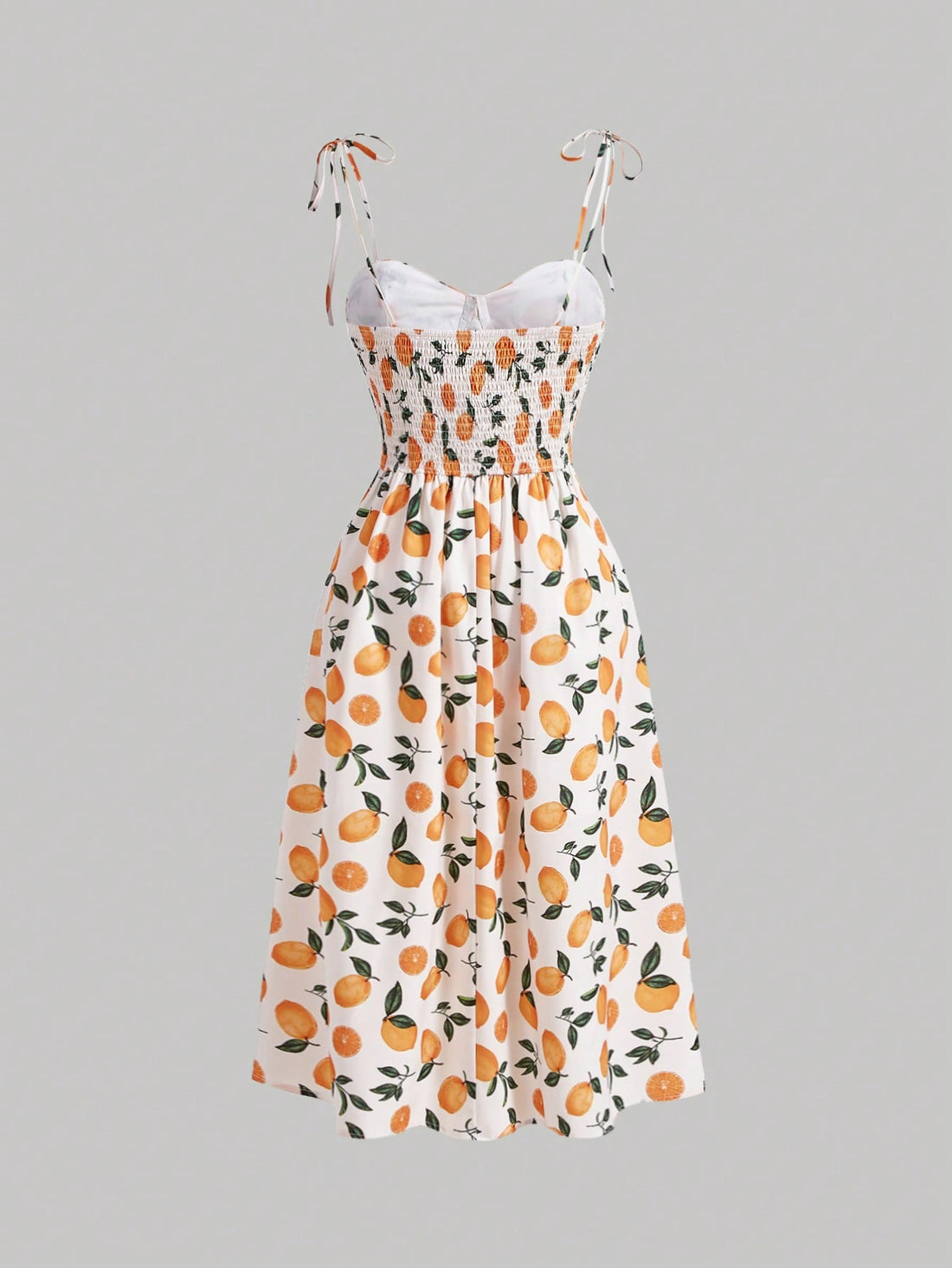 This cami dress is the perfect addition to your wardrobe, featuring a sunny lemon print and fun tie shoulder details. Brighten up any outfit with this quirky and playful piece. (Playful and quirky, this dress is sure to add some zest to your style! 🍋)
