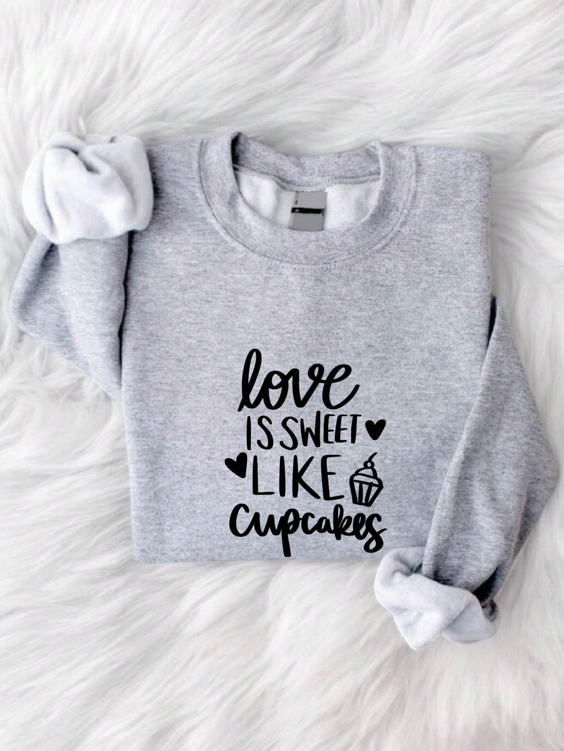 Indulge in love and dessert with our Sweet Love sweatshirt! Featuring a quirky "Love is Sweet Like Cupcakes" design, this Valentine's Day sweatshirt is perfect for any dessert lover. Stay cozy and sweet with our unique sweatshirt.