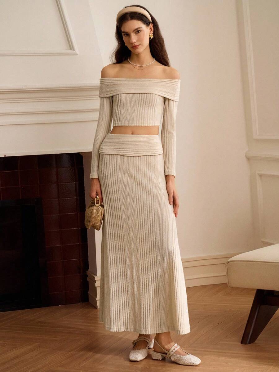 Elevate your festival wardrobe with this stunning boho two-piece set. The off-shoulder crop top features a rib-knit texture and three-quarter sleeves, while the flowing maxi skirt provides elegant coverage. Crafted from a comfortable polyester-elastane blend with medium stretch, this black ensemble transitions seamlessly from spring celebrations to evening events. Perfect for Eid gatherings, music festivals, or any occasion calling for modest, sophisticated style. Machine washable for easy care.