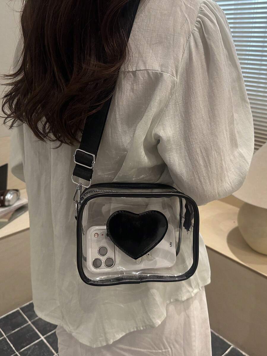Transparent PVC rectangular crossbody bag with black trim black heart front patch zipper top and adjustable black strap