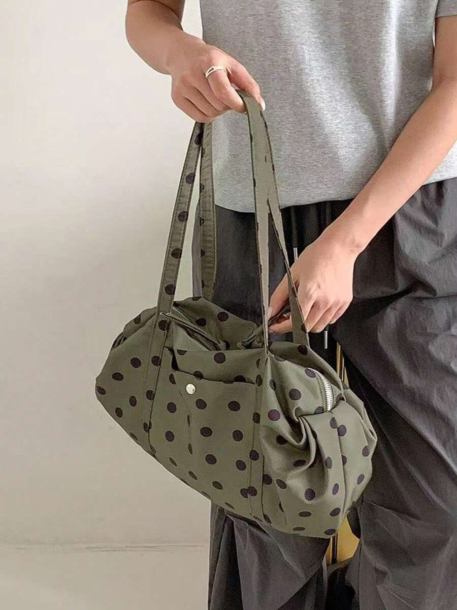 Olive green fabric shoulder tote bag with black polka dots long straps soft gathered sides worn on shoulder