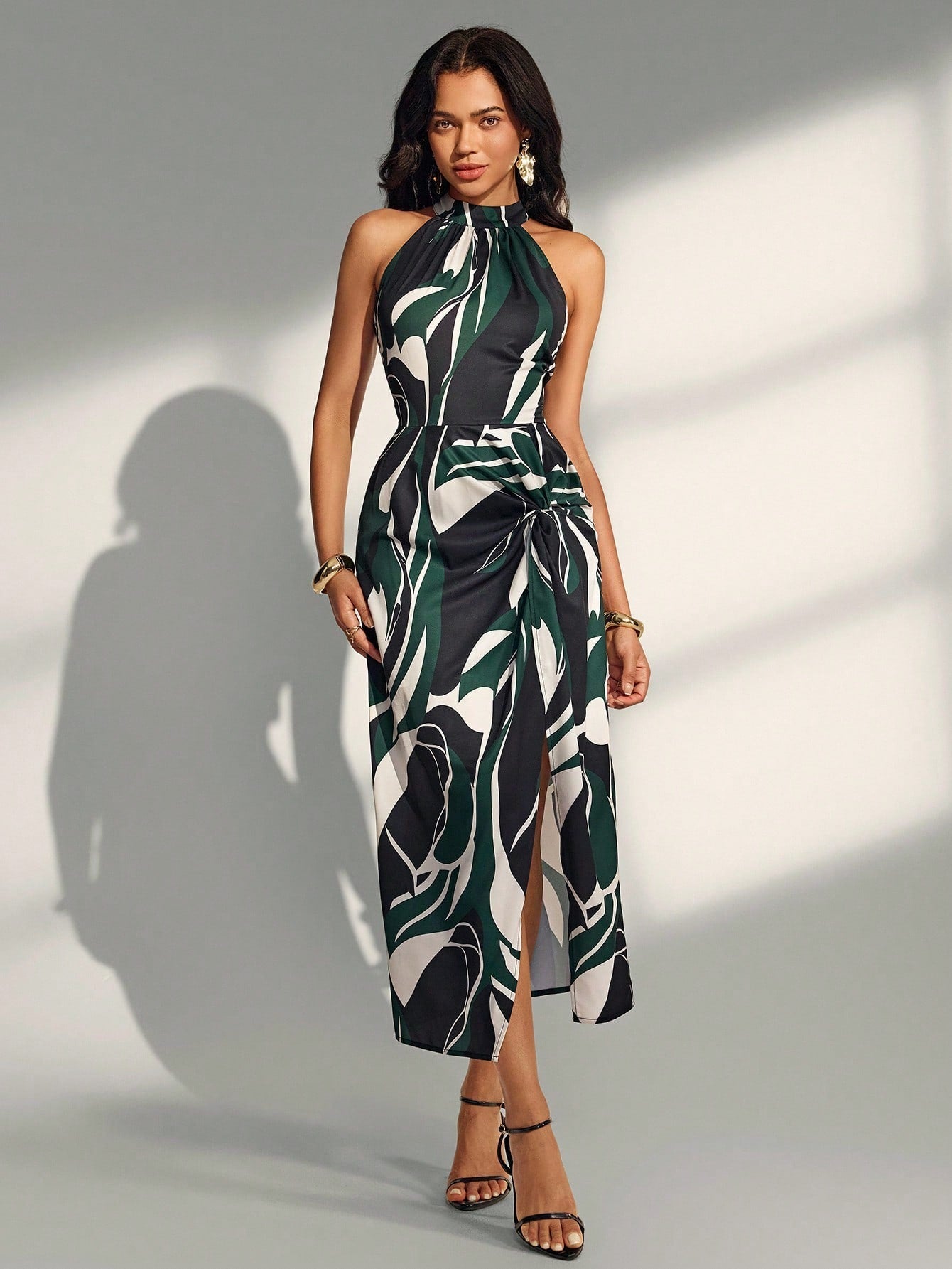 Effortlessly chic meets laid-back cool with the Alma Muse Sleeveless Long Dress. This spring and summer essential features a breezy sleeveless silhouette, eye-catching geometric print, and a playful button tie detail that lets you customize your look. The strategic slit adds movement and flair, making it perfect for everything from casual brunches to sunset strolls. Lightweight and versatile, it's the dress that does it all without trying too hard.