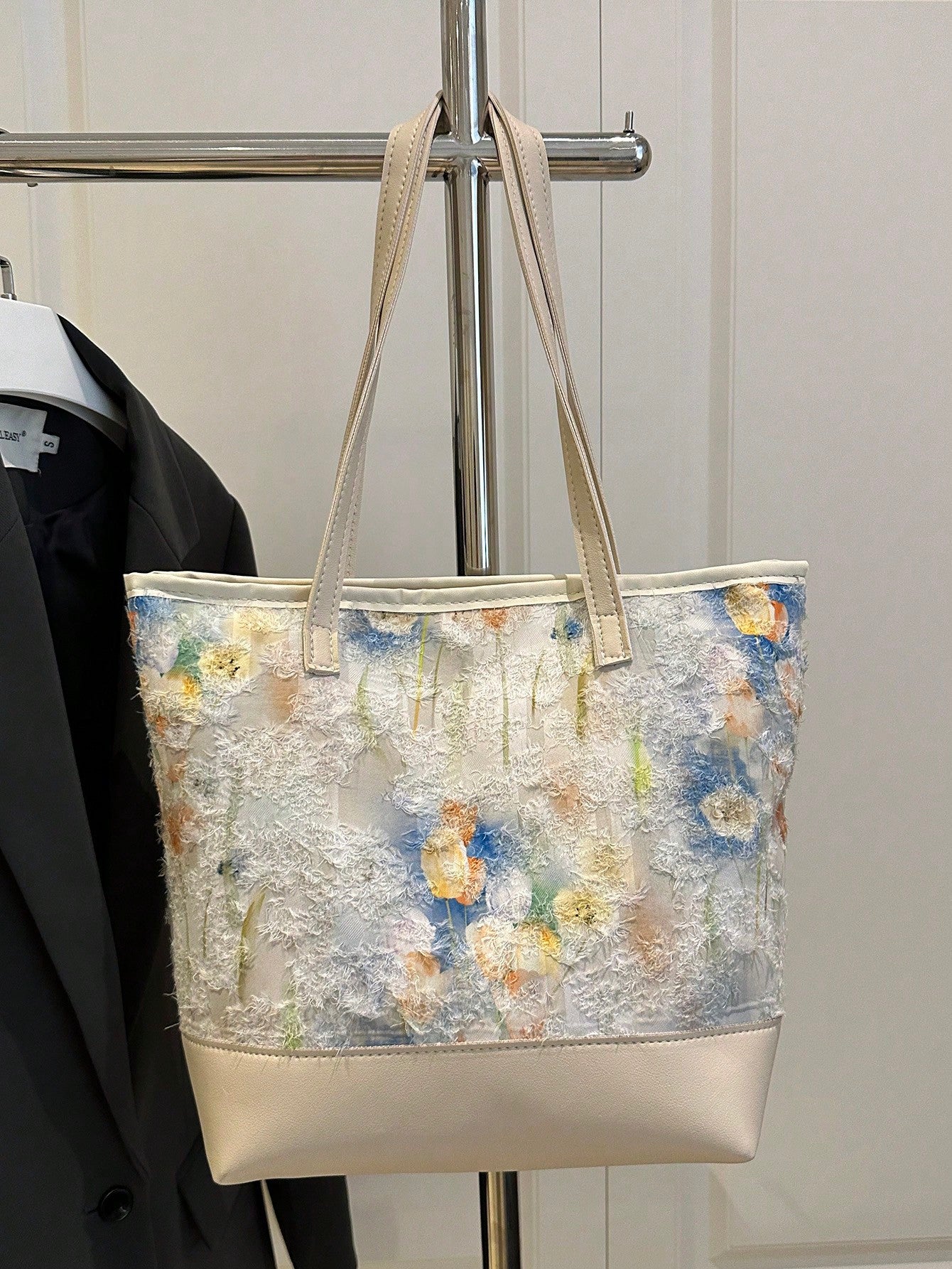 Brighten your summer days with this trendy beige nylon tote bag adorned with a charming flower pattern. Lightweight and spacious, it’s perfect for carrying all your essentials, whether you’re heading to the beach, market, or a casual outing. Durable yet stylish, this versatile tote adds a playful touch to any outfit while keeping you organized on the go.