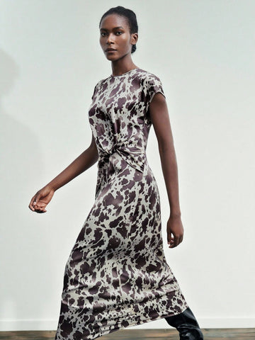 Step into summer with this playful cow print satin midi dress that effortlessly wraps you in style. Its smooth satin fabric glides over your skin, while the flattering wrap design highlights your silhouette with a fun, flirty twist. Perfect for sunny days and breezy evenings, this dress adds a quirky edge to your wardrobe without sacrificing comfort. Make every moment a little wilder and a lot more stylish!