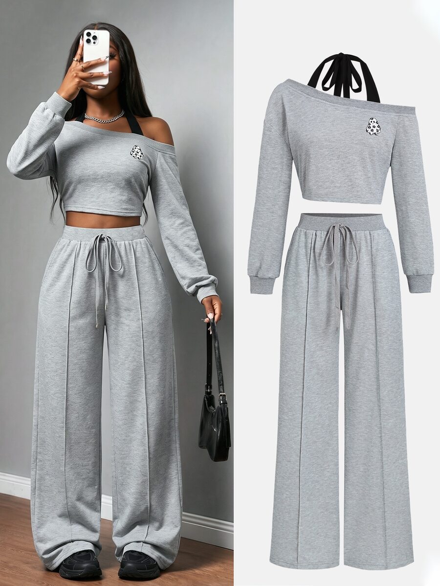 Front view of grey Halloween asymmetric crop sweatshirt and wide-leg pants set