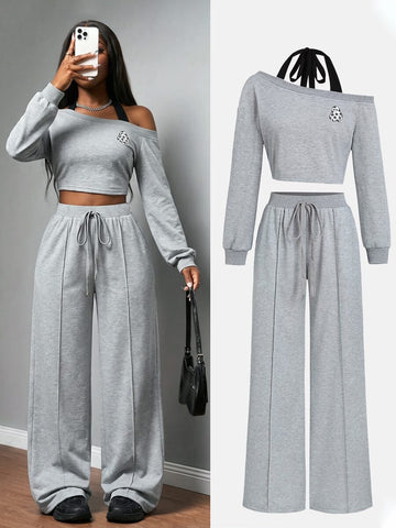 Front view of grey Halloween asymmetric crop sweatshirt and wide-leg pants set