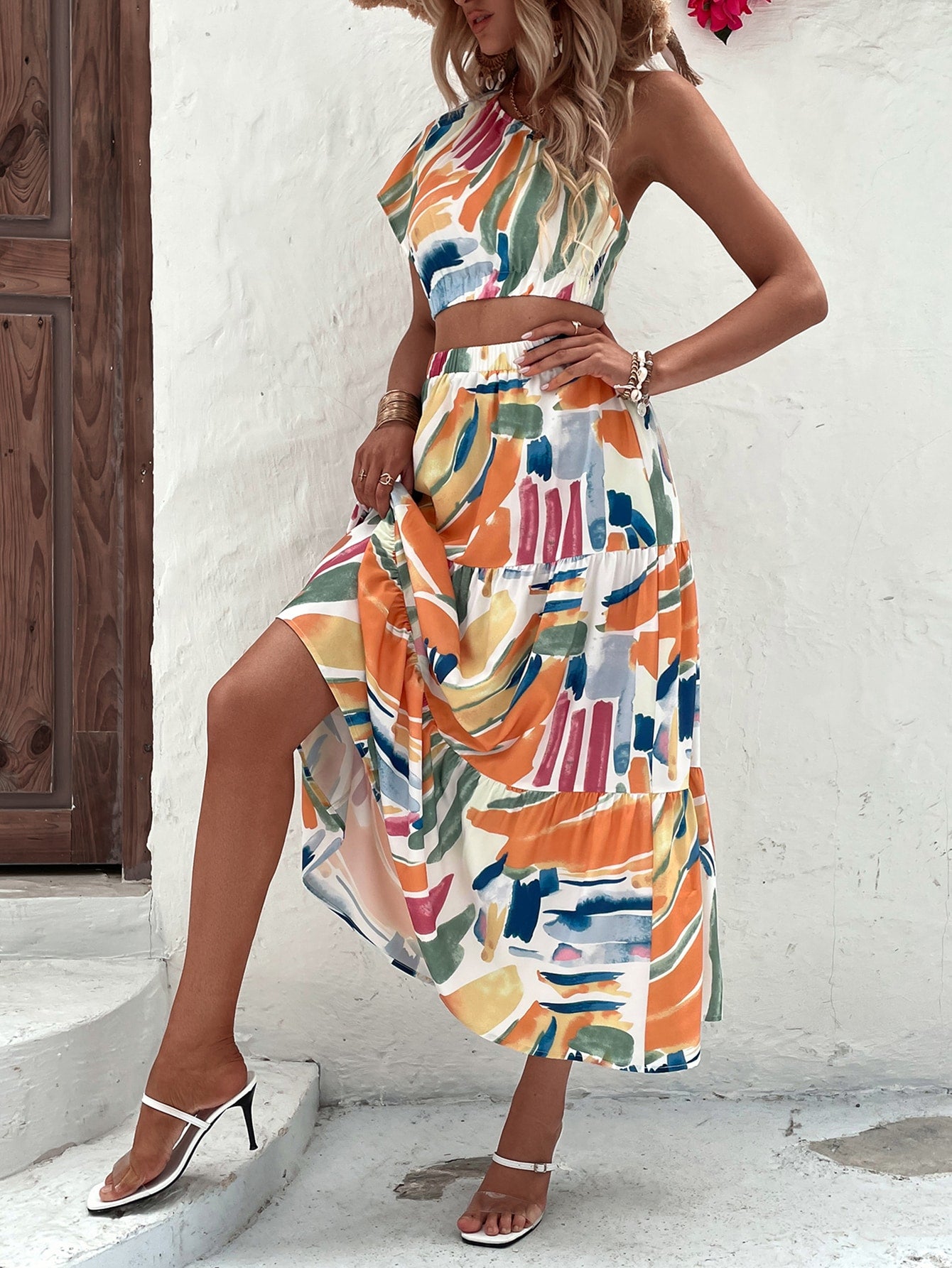 Turn heads this season with our chic one-shoulder crop blouse paired perfectly with a flowy ruffle hem skirt. The asymmetrical neckline adds instant edge while the cropped silhouette keeps things modern and fresh. Layer the soft, breathable blouse with the skirt's playful ruffles for a look that's equal parts fun and fabulous. Whether you're hitting the beach, catching sunset drinks, or dancing the night away, this dynamic duo delivers effortless summer vibes with serious style credentials. Mix, match, and 