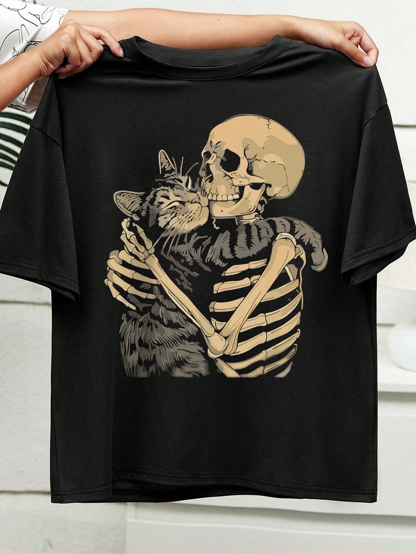 Unleash your inner feline with this trendy plus size cat graphic tee! Featuring a skull cat design, this casual tee is perfect for cat lovers and fashionistas alike. Made with high-quality materials, it's both stylish and comfortable. Get ready to rock your casual looks with this purrfect graphic tee.
