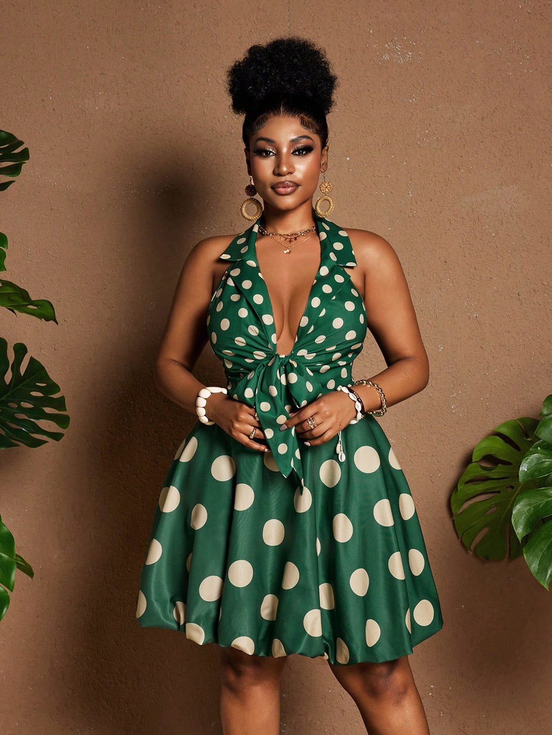 Flaunt your curves in this playful polka dot bubble mini dress! The halter neckline and front tie detail add flirty charm, while the trendy silhouette ensures you'll stand out at any occasion. This plus-size stunner combines comfort with head-turning style for the confident woman who loves to make a statement.