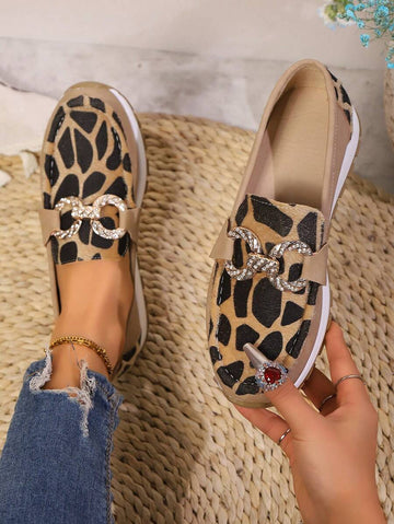Step into effortless style with these eye-catching plus size wedge loafers. Featuring a bold leopard print design accented with a sleek metal chain detail, these shoes deliver personality and comfort in one package. The cushioned wedge sole provides all-day wearability, whether you're running errands around town or exploring new destinations. The roomy fit accommodates wider feet while the elevated heel adds a flattering lift to any casual outfit. Perfect for pairing with jeans, dresses, or weekend wear