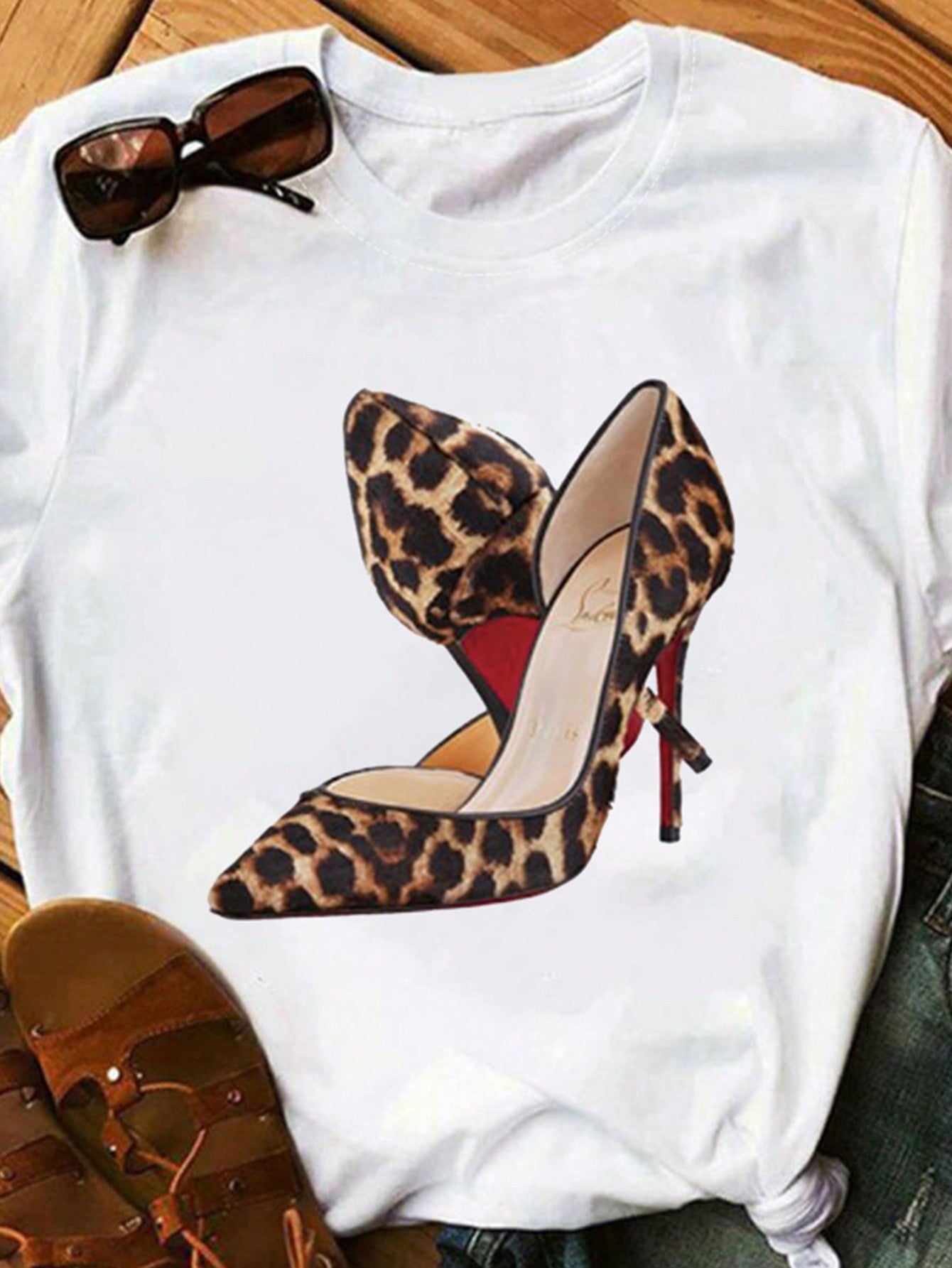 Elevate your everyday style with this playful and trendy plus size women's t-shirt, featuring a minimalist high heel print. Perfect for any fashion-forward woman, this t-shirt adds a touch of fun and flair to any outfit. Strut your stuff in comfort and style with this must-have wardrobe staple!