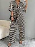 Front view of striped belted wide-leg jumpsuit showing visible color, print, and silhouette