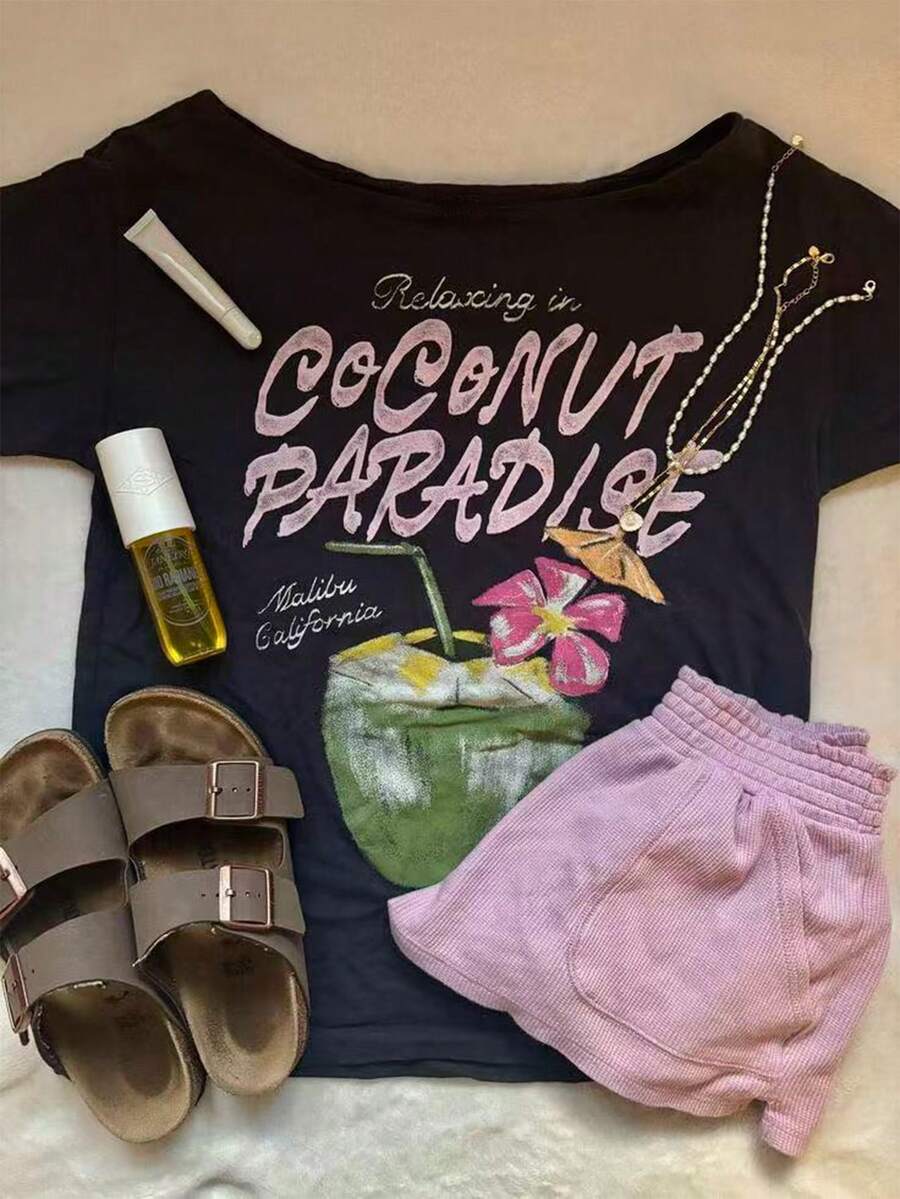 Front flat-lay of dark wide-neck T-shirt with Coconut Paradise tropical drink graphic