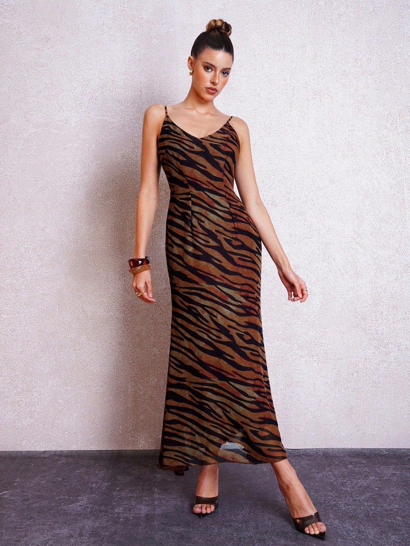 Turn heads this summer with our Trendy Women's Open Back Tiger Stripe Spaghetti Strap Dress. Its bold tiger stripe pattern and flirty open back make it the perfect choice for sunny outings and graduation celebrations. Lightweight and breezy, this dress keeps you cool while adding a playful edge to your look. Embrace effortless style and confidence wherever you go!