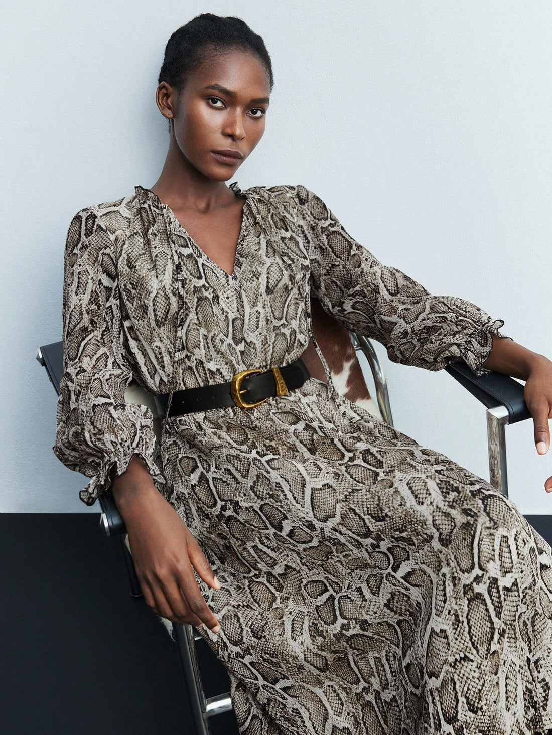Step out in style with this trendy midi dress featuring a wild snake skin print, playful ruffle sleeves, and a chic keyhole twist collar. Perfect for turning heads at brunch or date night, its flattering silhouette combines comfort with bold fashion flair. Embrace your daring side while keeping things effortlessly fun and feminine.