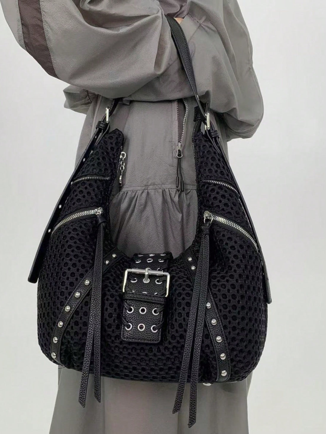 Add a playful pop to your look with this Y2K-inspired half moon shoulder bag. Packed with multiple zippers and adorned with chic tassel details, it keeps your essentials organized while turning heads. Perfect for everyday adventures, this bag combines retro flair with modern practicality for stylish fun on the go.