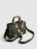 Three-quarter view of army green camouflage fabric handbag with rounded handles and black shoulder strap