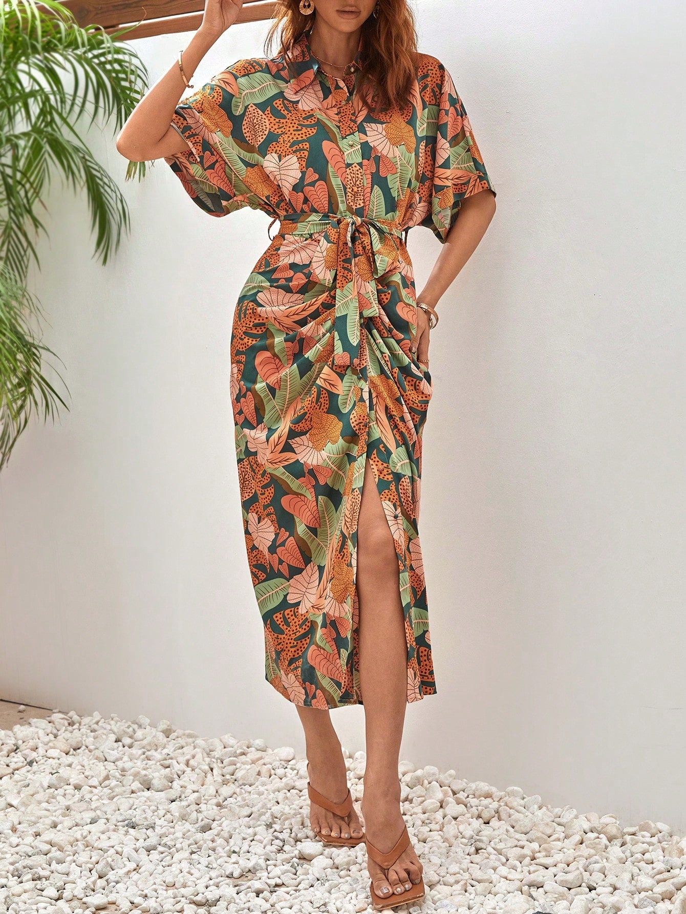 Get ready to turn heads in our Tropical Elegance dress! Featuring a chic batwing sleeve design and figure-flattering ruching and belted waist, this dress will elevate your style with a touch of tropical charm. Perfect for any occasion, this playful dress will have you feeling elegant and effortlessly stylish.