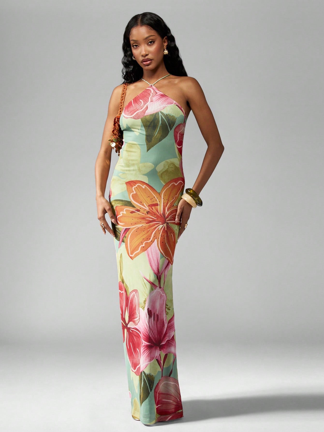 Turn heads this summer with our Tropical Floral Halter Neck Maxi Dress, perfect for sunny beach days and special occasions alike. Its vibrant floral print and flowing silhouette bring a playful, breezy vibe to your wardrobe, making every step feel like a tropical getaway. The halter neck design adds a flirty touch while keeping you cool and comfortable under the sun. Whether you're strolling along the shore or dancing into the evening, this dress is your go-to for effortless summer style and endless fun.
