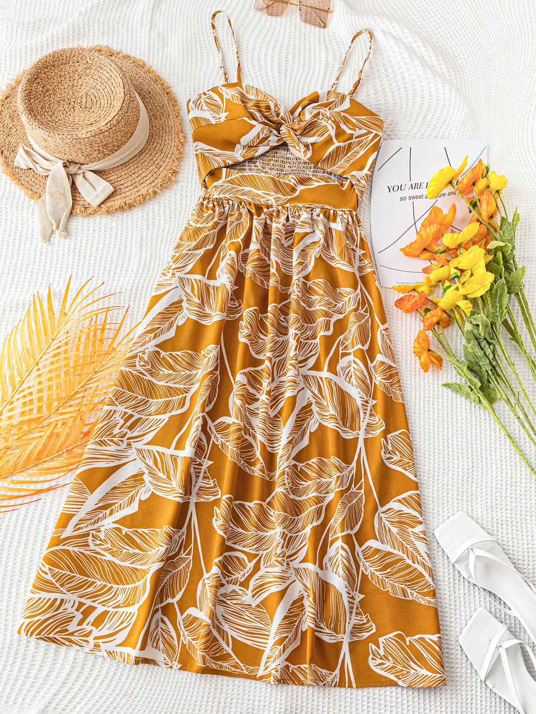 Sway into summer with this eye-catching tropical leaf print dress! The vibrant yellow fabric and flirty spaghetti straps create an instant vacation vibe, while the twist front detail adds a touch of sophistication. Perfect for beach days, island getaways, or simply bringing sunshine to your everyday wardrobe. This breezy number will have you feeling fabulous with minimal effort!