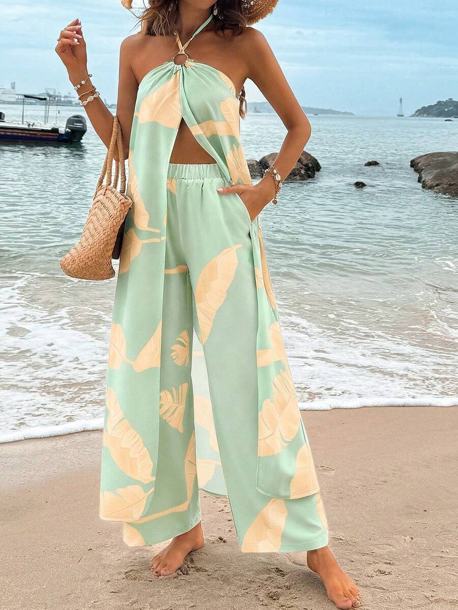 Escape to paradise with the Breezaya Two-Piece Set, your ultimate summer companion. This tropical-inspired ensemble features a flattering halter crop top paired with comfortable straight-leg pants, perfect for beach days, resort lounging, or casual getaways. The breathable fabric keeps you cool in warm weather while the vibrant design captures that carefree vacation spirit.