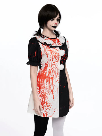 Front view of black white harlequin clown dress with red splatter puff sleeves and pom poms